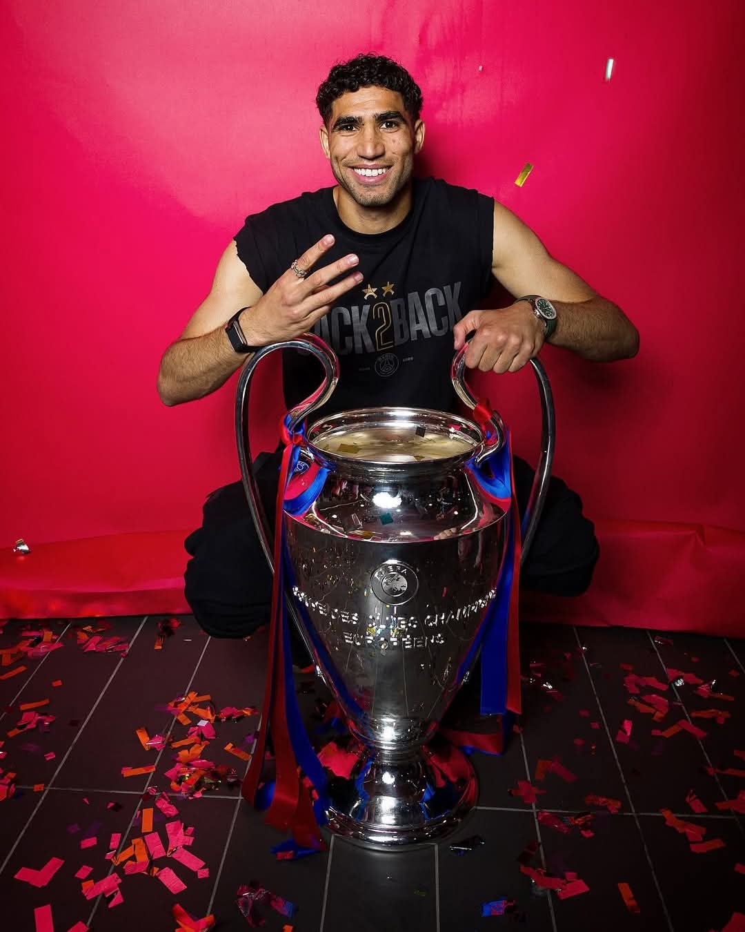 Achraf Hakimi smiling with a major football trophy