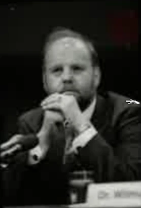 Ian Wilmut seated at a microphone during a 1997 US Senate hearing.